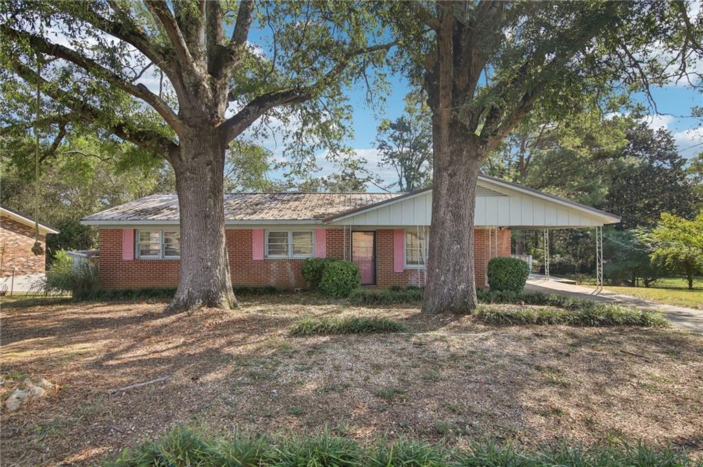 a view of a house with a tree in the yard