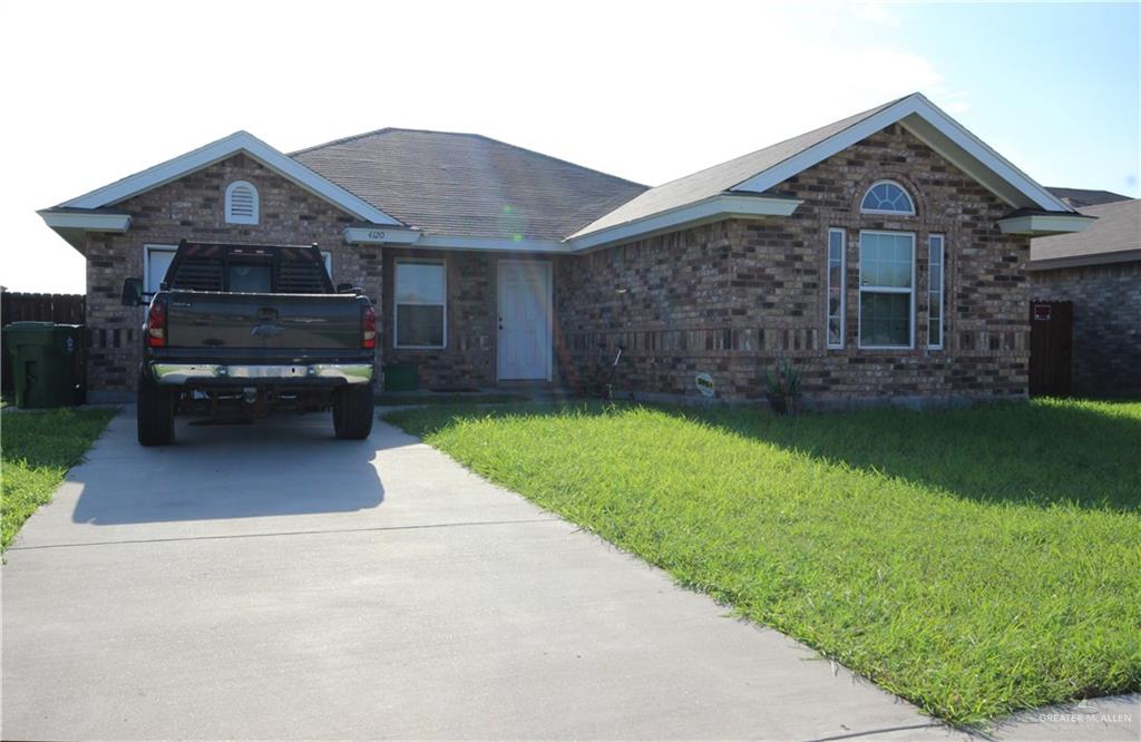 a front view of a house with a garden and yard