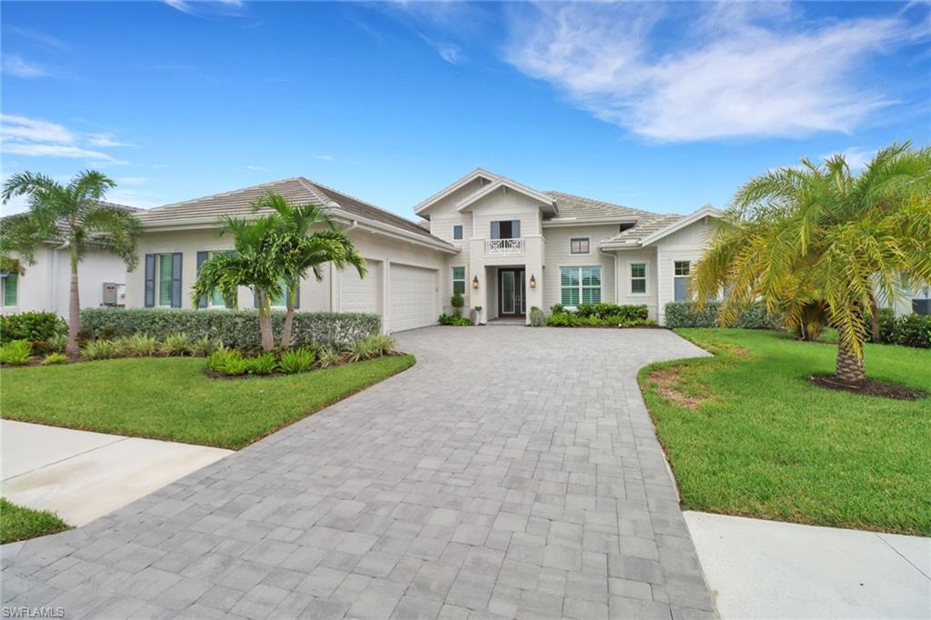 View of front of home featuring a garage and a front yard