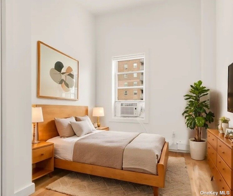 a bedroom with bed and a potted plant