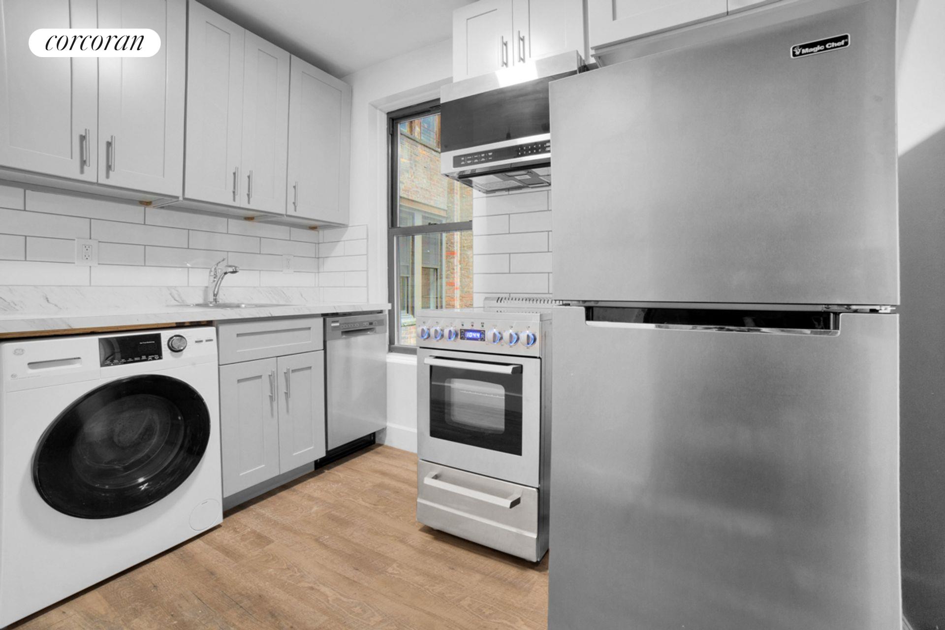 a kitchen with a washer and dryer