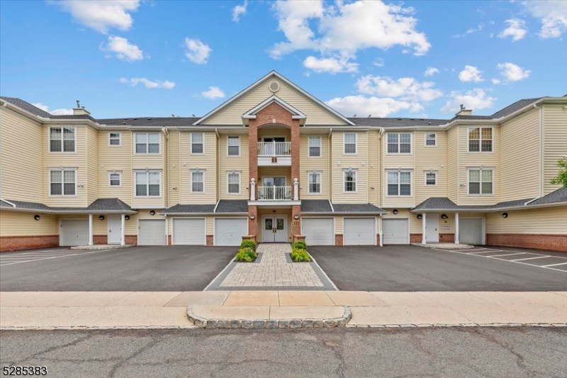 a front view of a residential apartment building with a yard