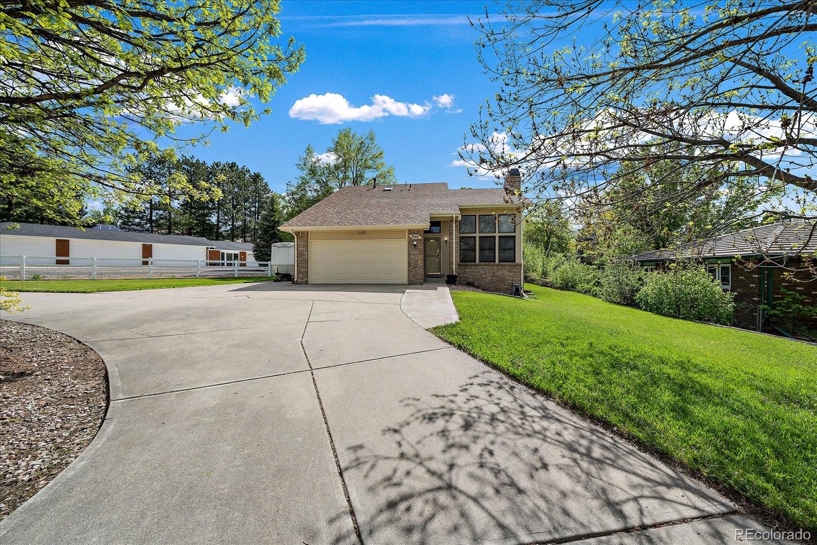 a view of a house with a yard and tree s