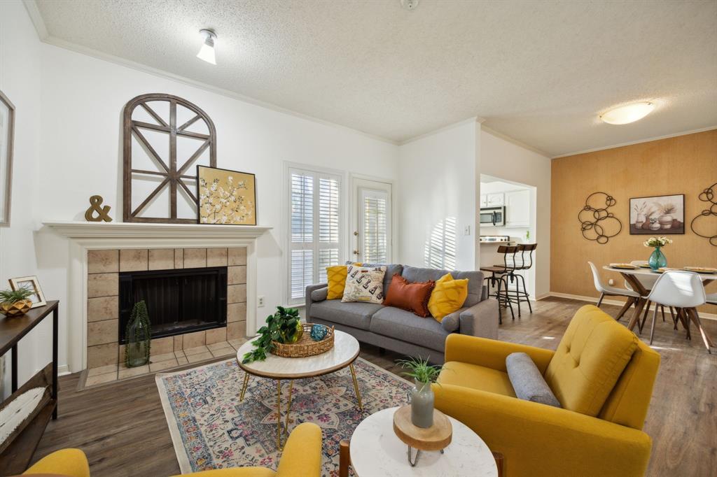 a living room with furniture a fireplace and a table