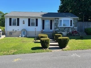 a front view of house with yard and outdoor seating