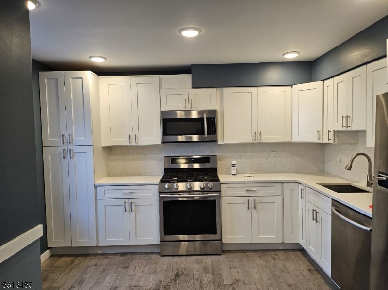 a kitchen with a sink stove and microwave