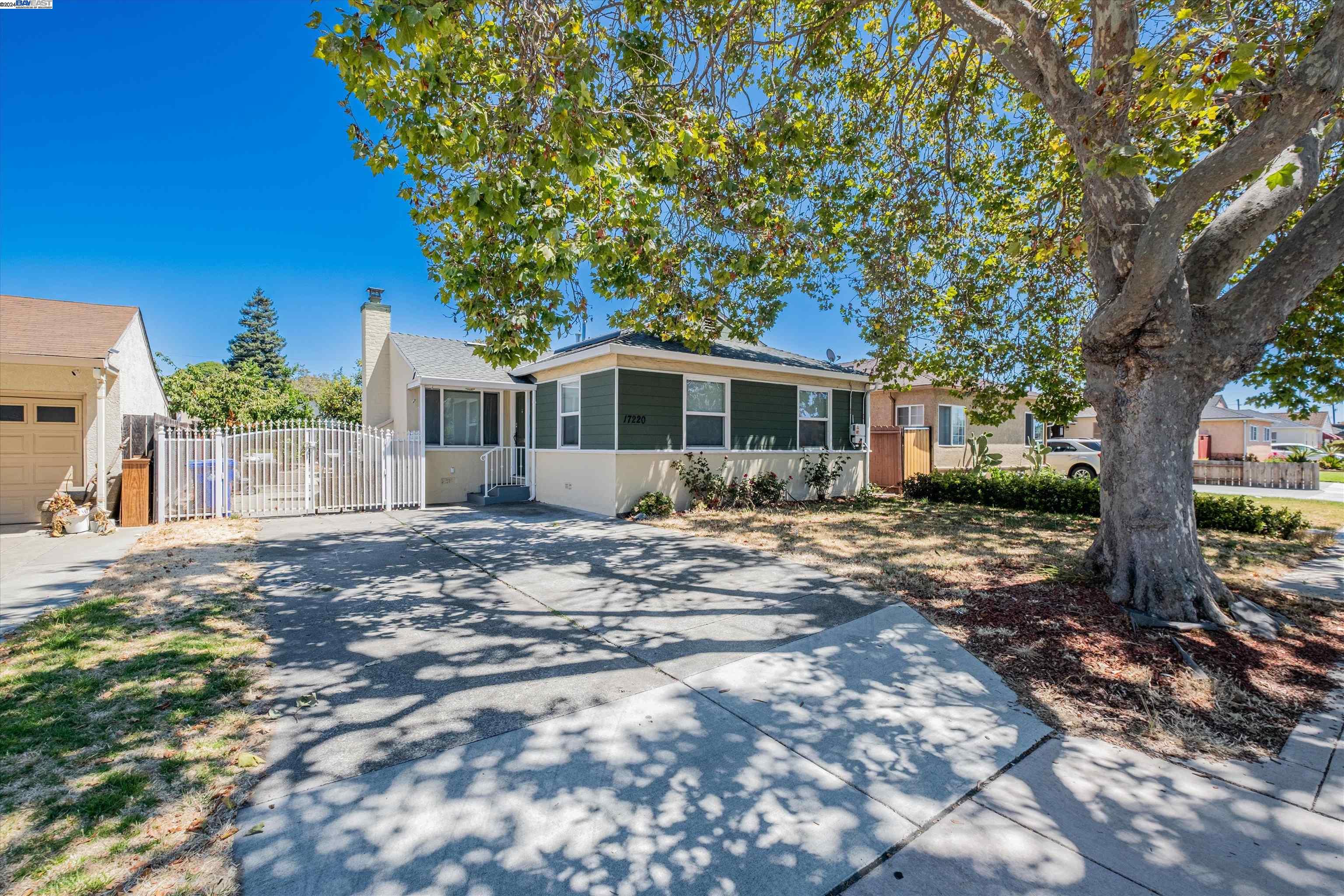 a view of a house with a tree in the background