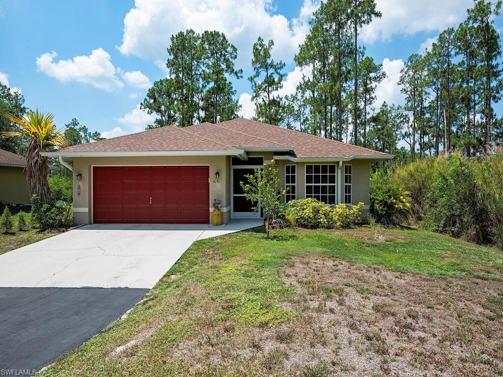 a front view of a house with a garden