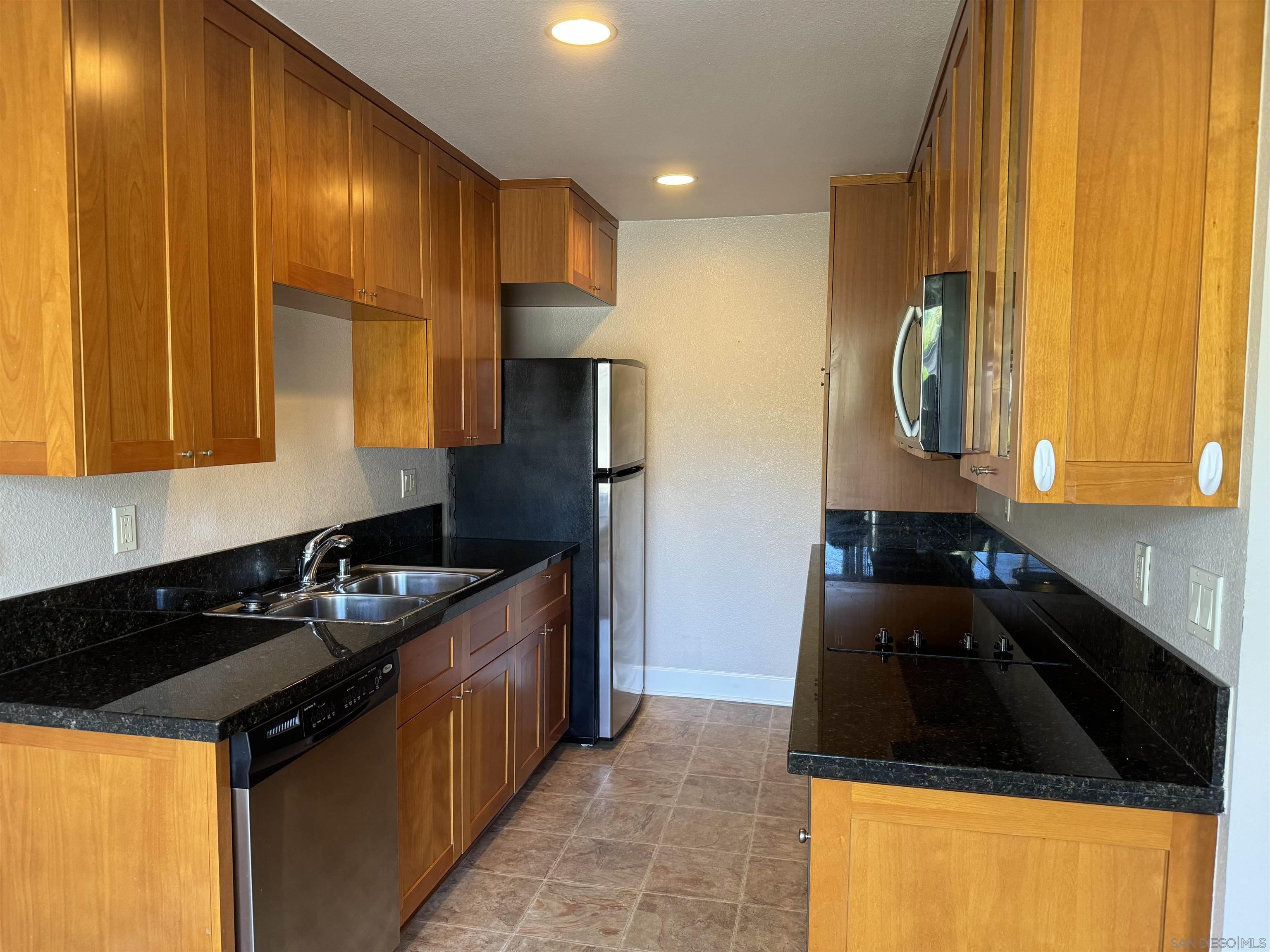 a kitchen with a sink a stove and refrigerator