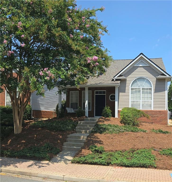 a front view of a house with garden