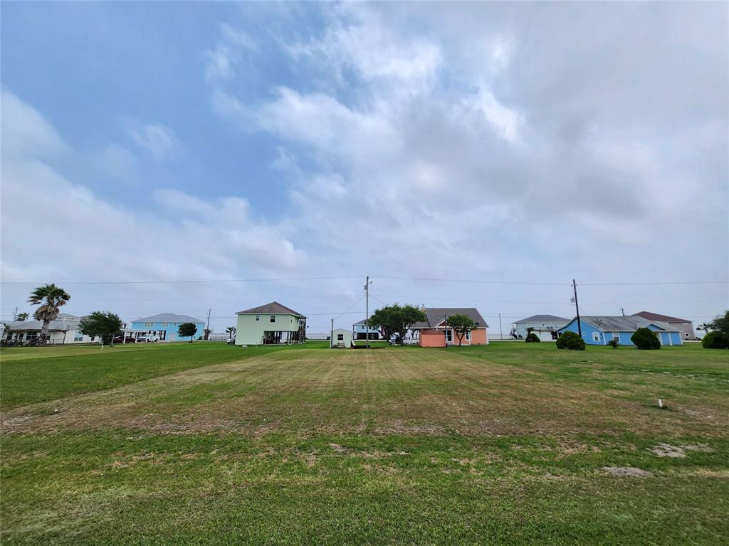 a view of a field with parked cars