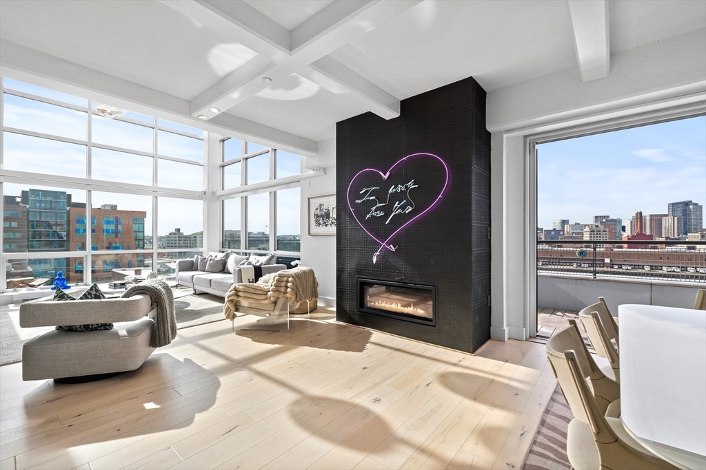 a very nice looking living room with a large window and a fireplace