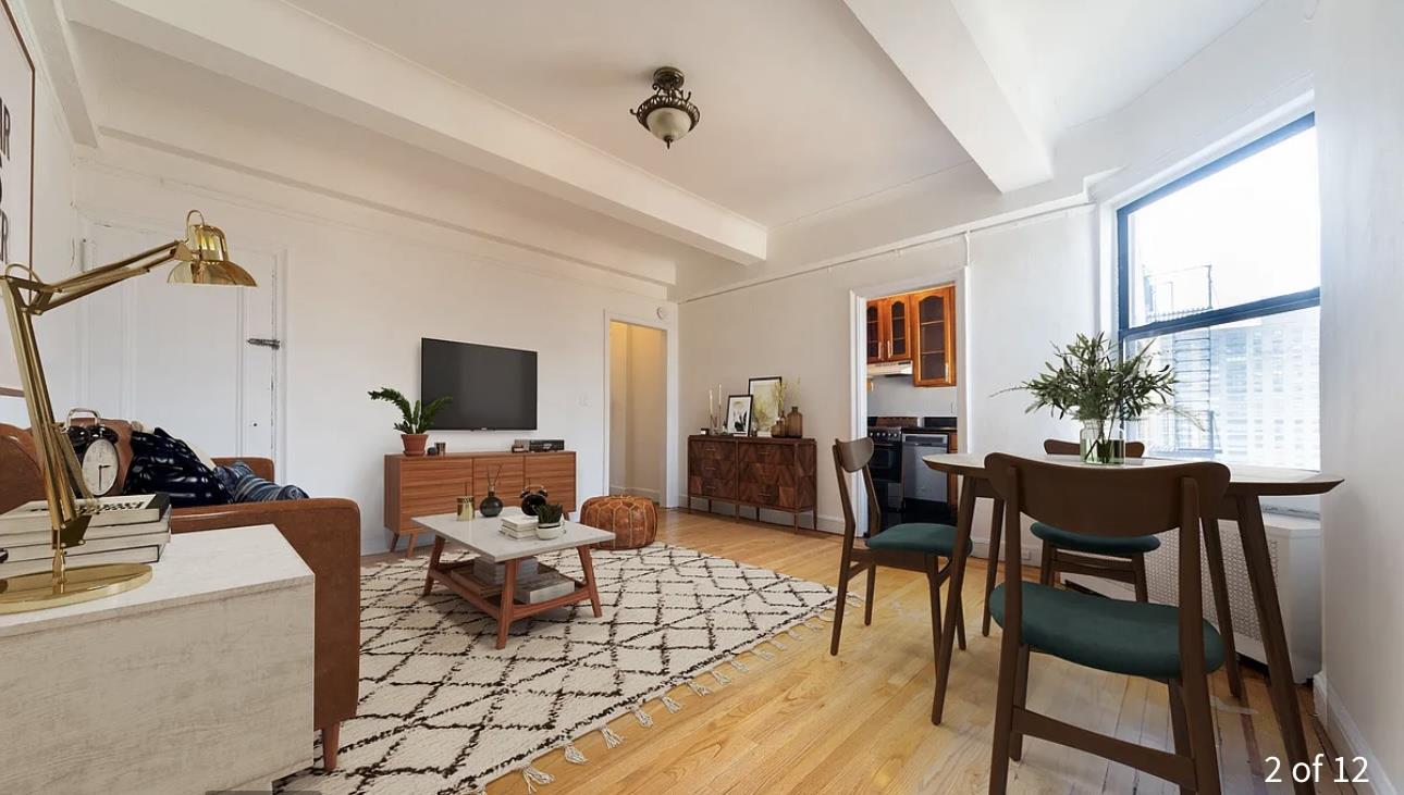 a living room with furniture a flat screen tv and a table