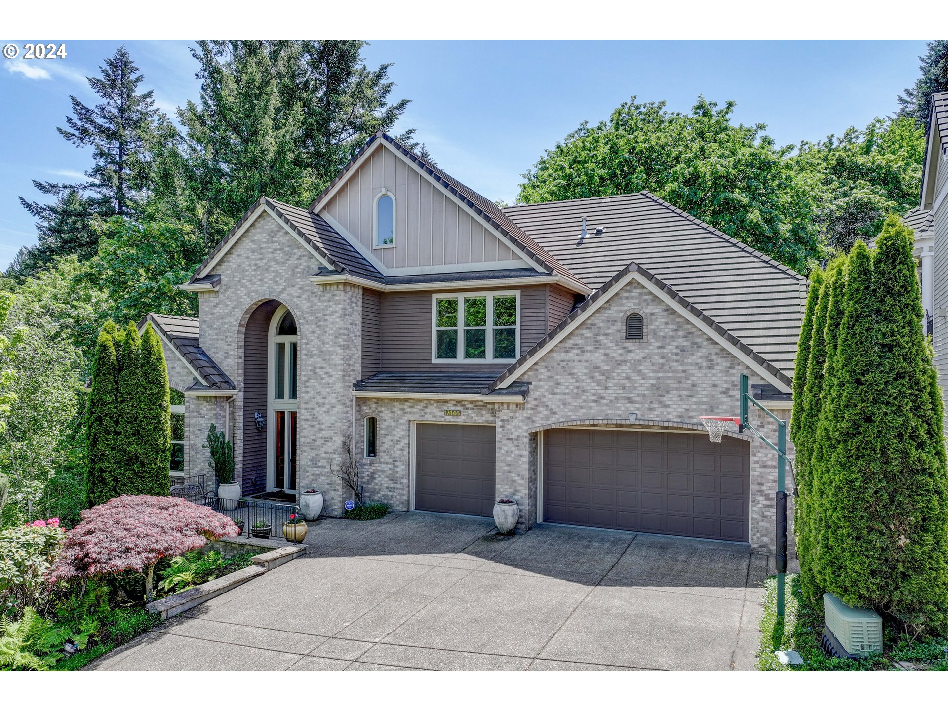 a front view of a house with a yard and garage