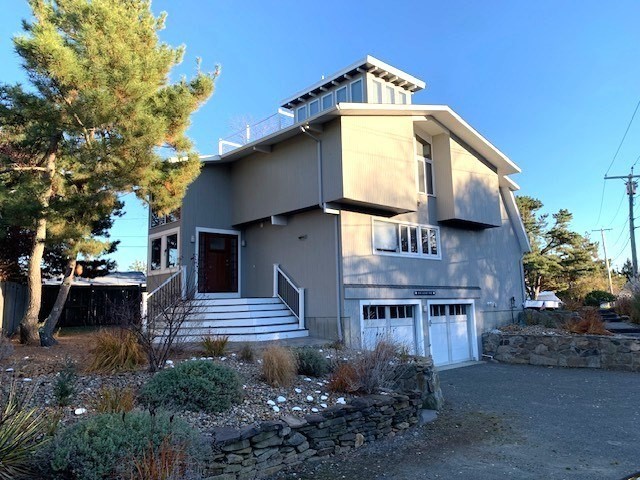 a front view of house with a garden