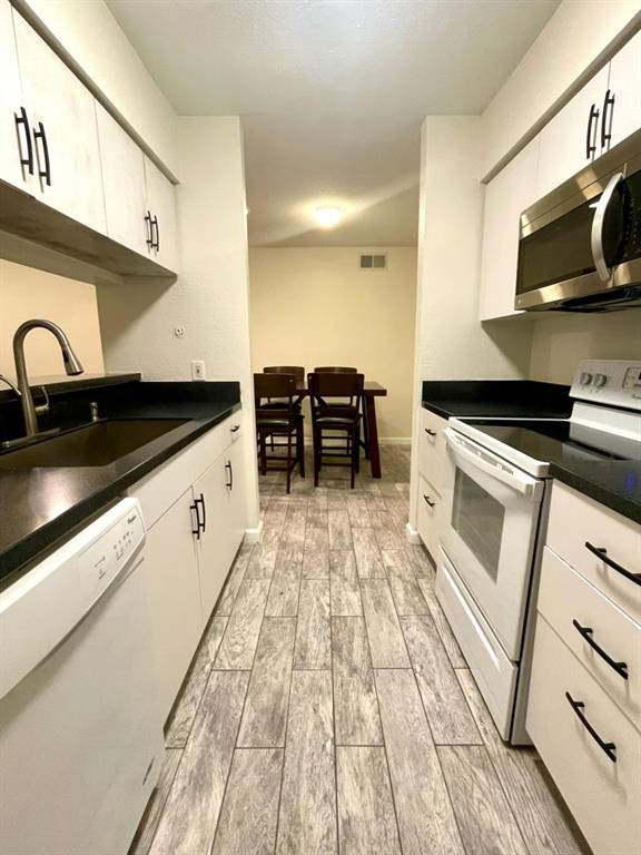 a kitchen with stainless steel appliances a stove a sink and a microwave