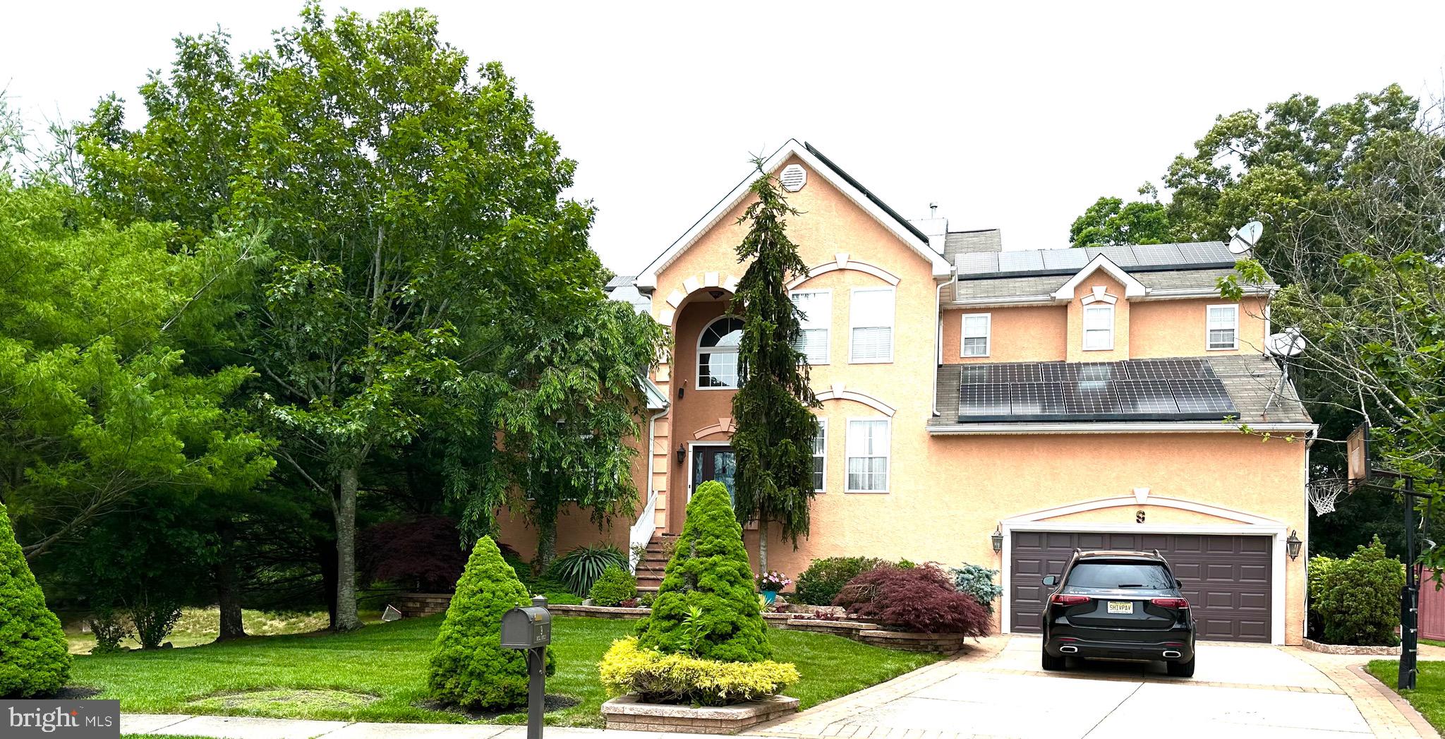 a front view of a house with a garden