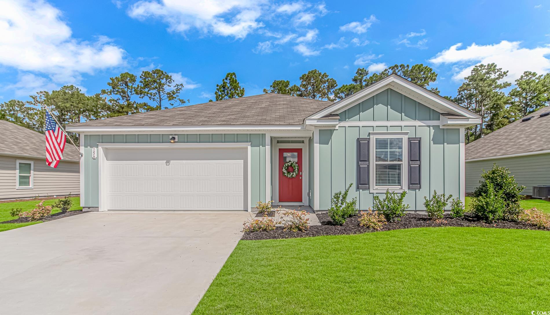 Ranch-style home with a garage and a front lawn