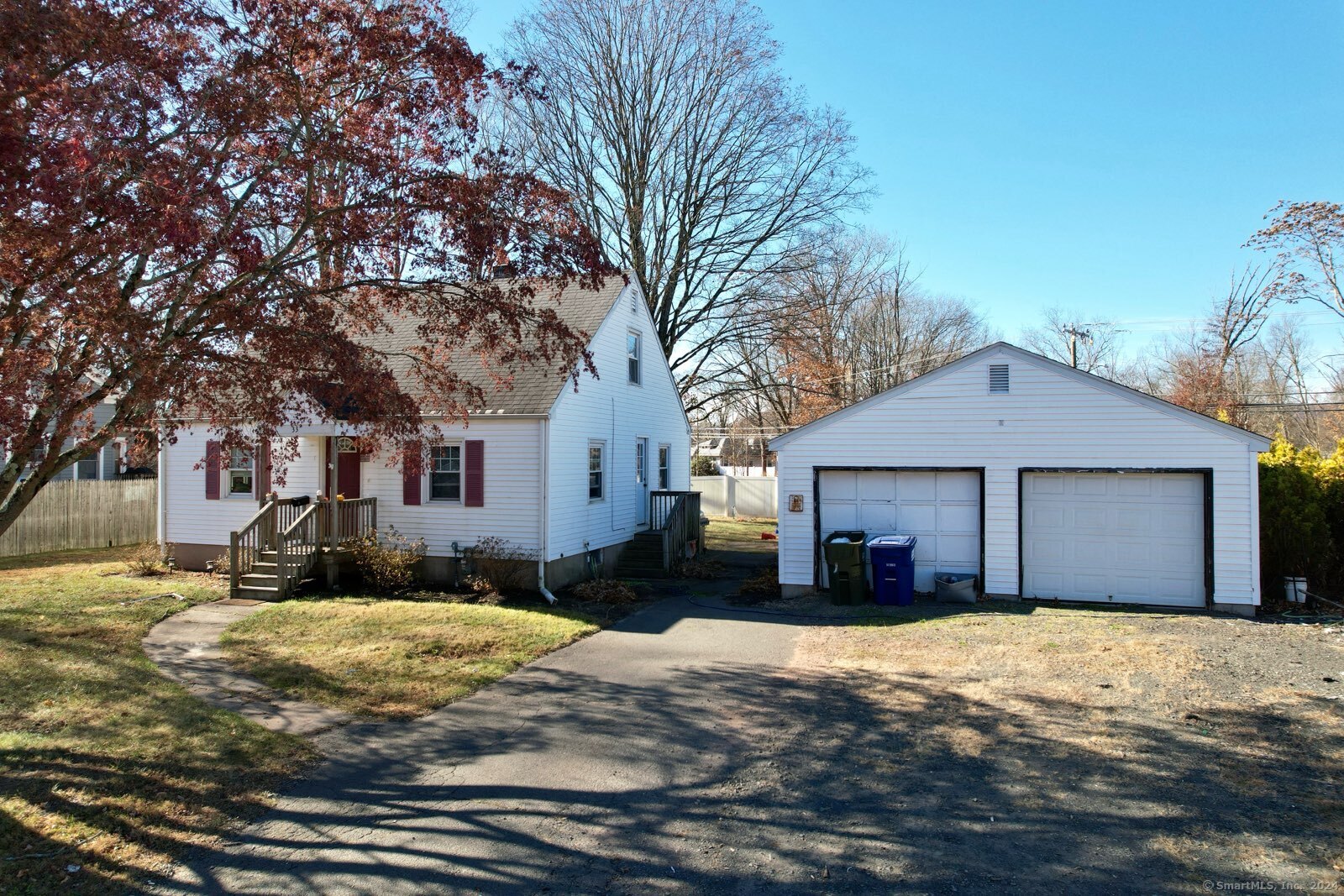 a front view of a house with a yard covered in snow