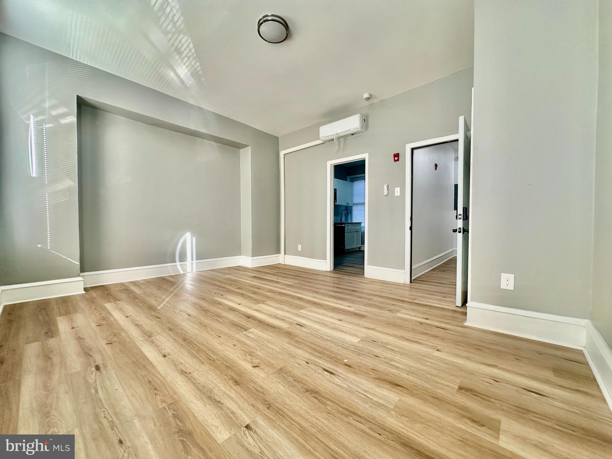 a view of empty room with wooden floor