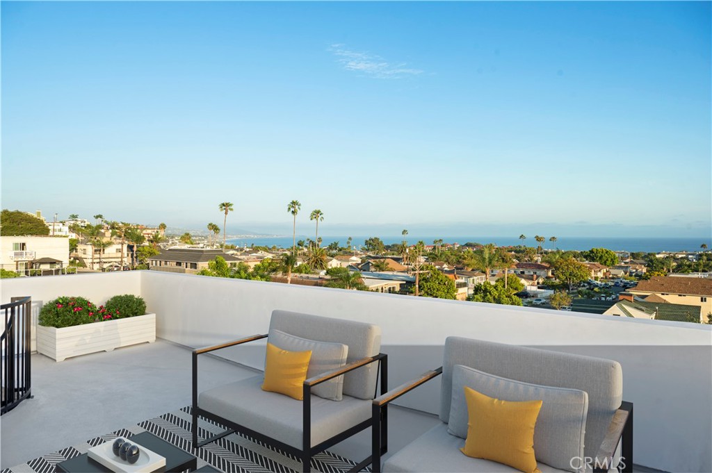 Roof Top Deck with expansive panoramic White Water Ocean View Photo has been virtually staged