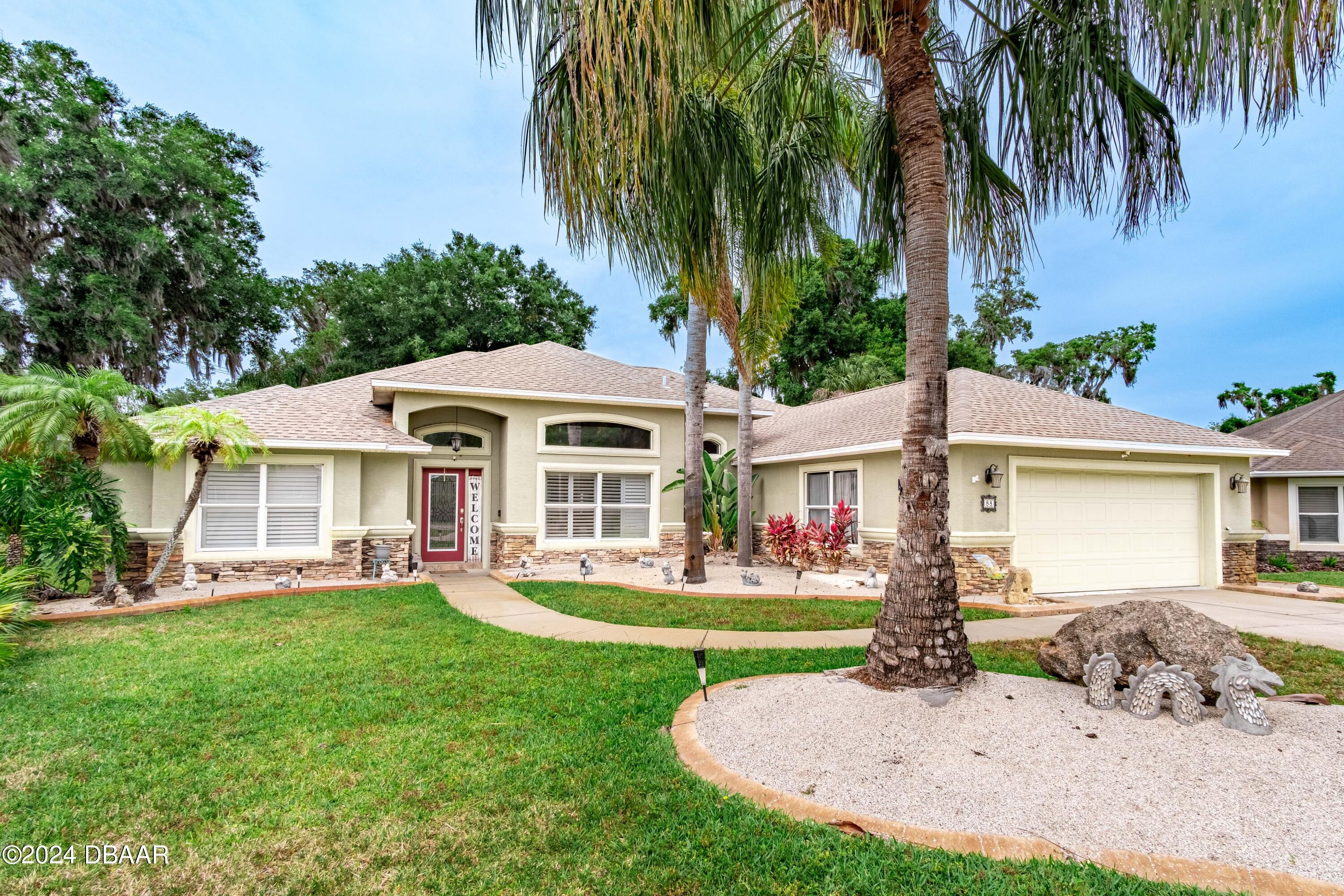 a front view of house with yard and green space