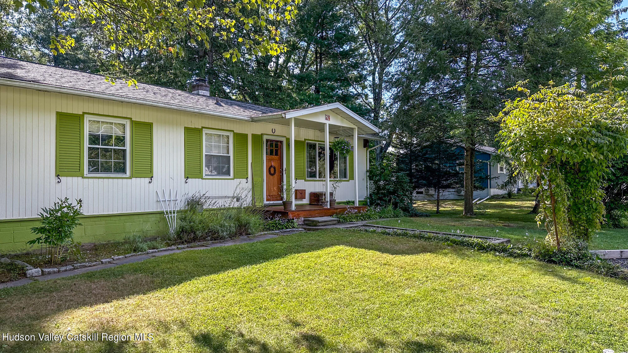 a view of a house with a yard and sitting area