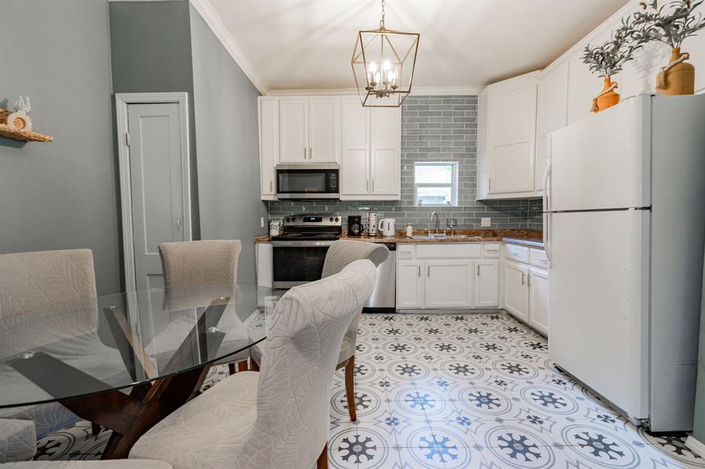 a kitchen with stainless steel appliances a refrigerator sink and cabinets