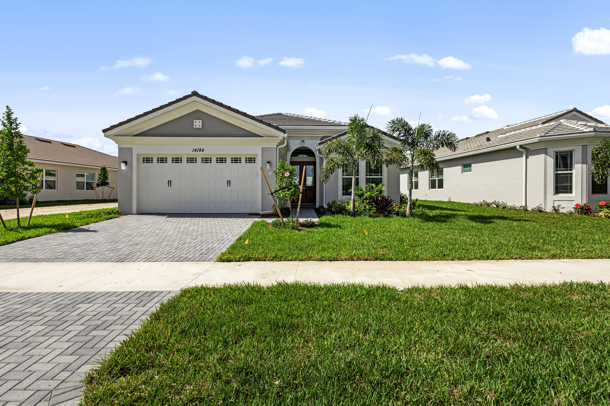 a front view of a house with a yard and garage