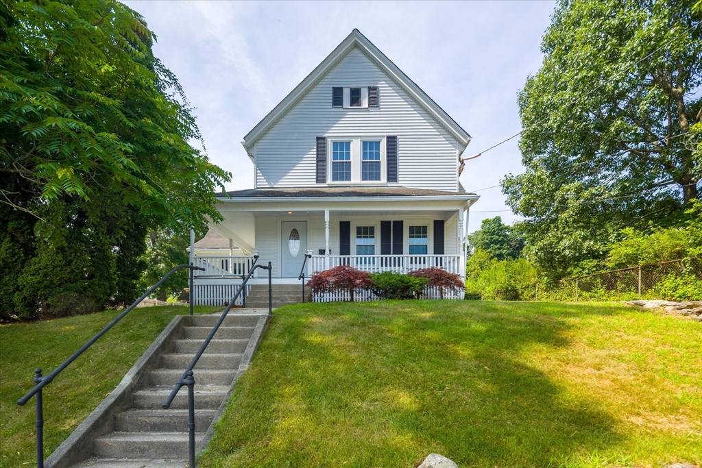 a front view of house with yard and green space