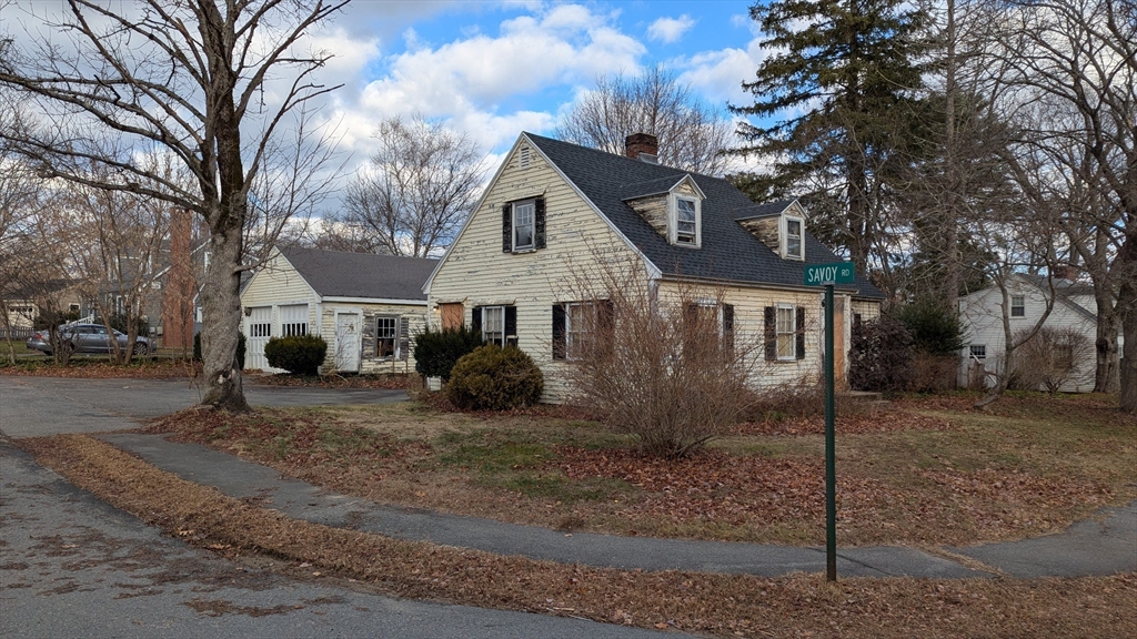 a view of a house with a yard covered in snow