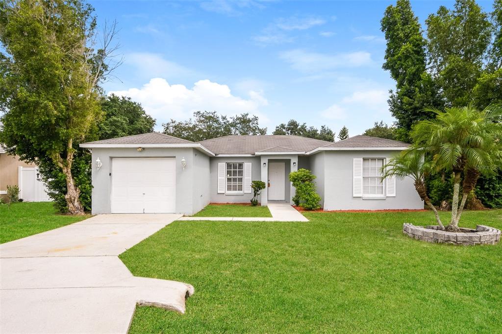 a view of a house with a yard and tree s