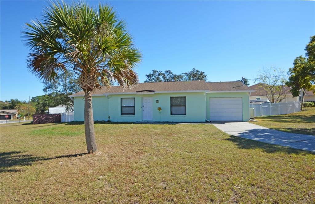 a view of a house with a yard and garage