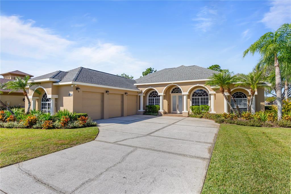 a front view of a house with a yard and garage