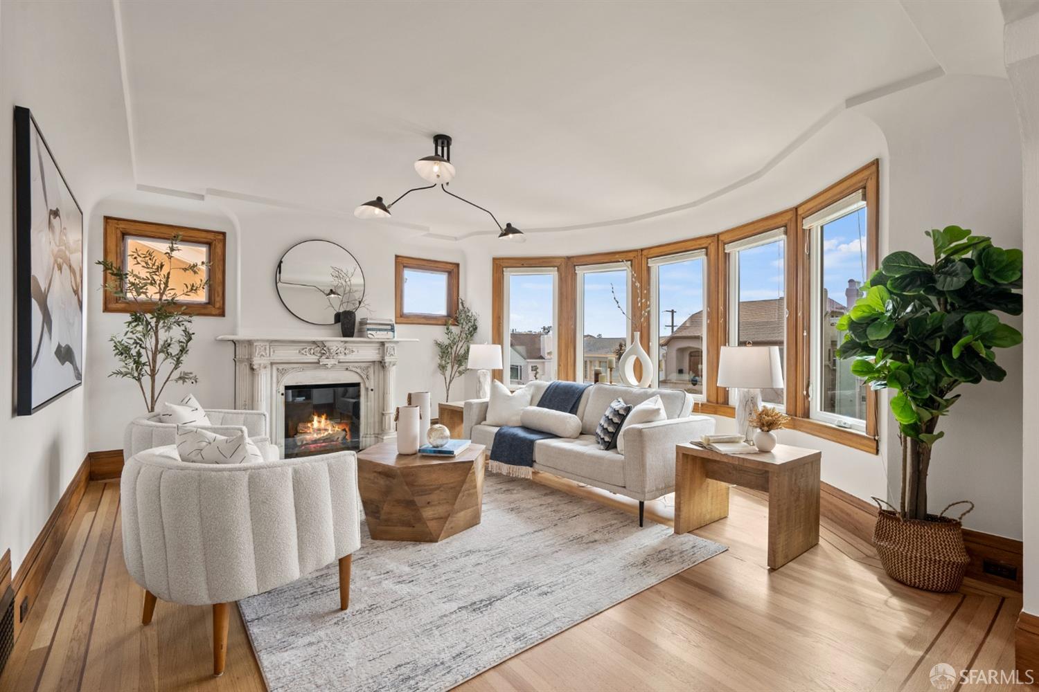 a living room with furniture a fireplace and a large window