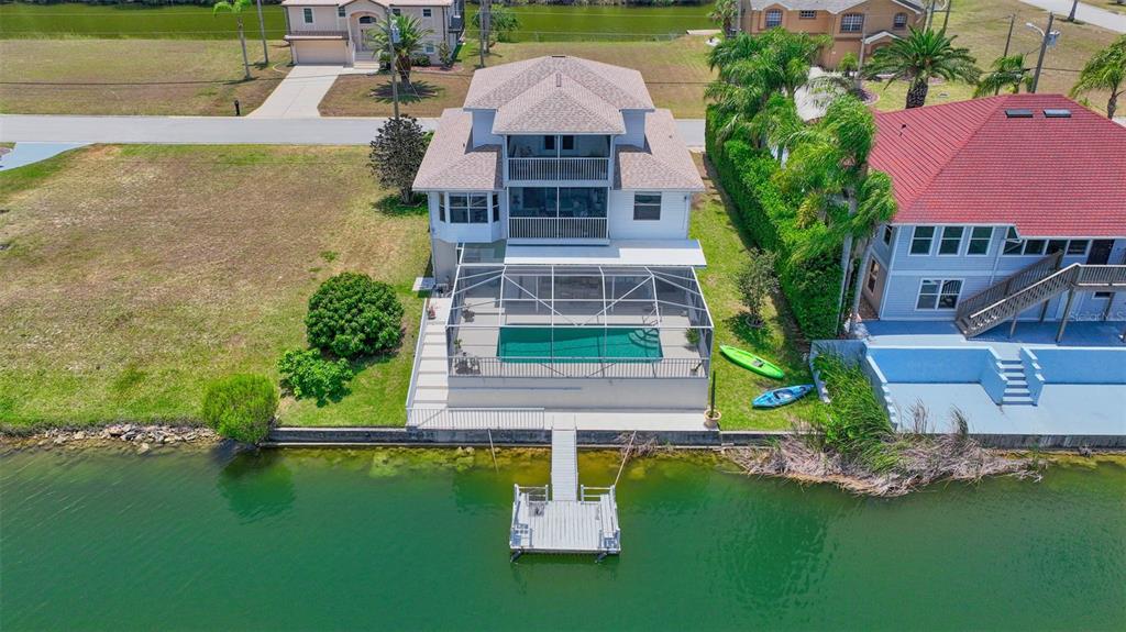 an aerial view of a house with a garden and swimming pool