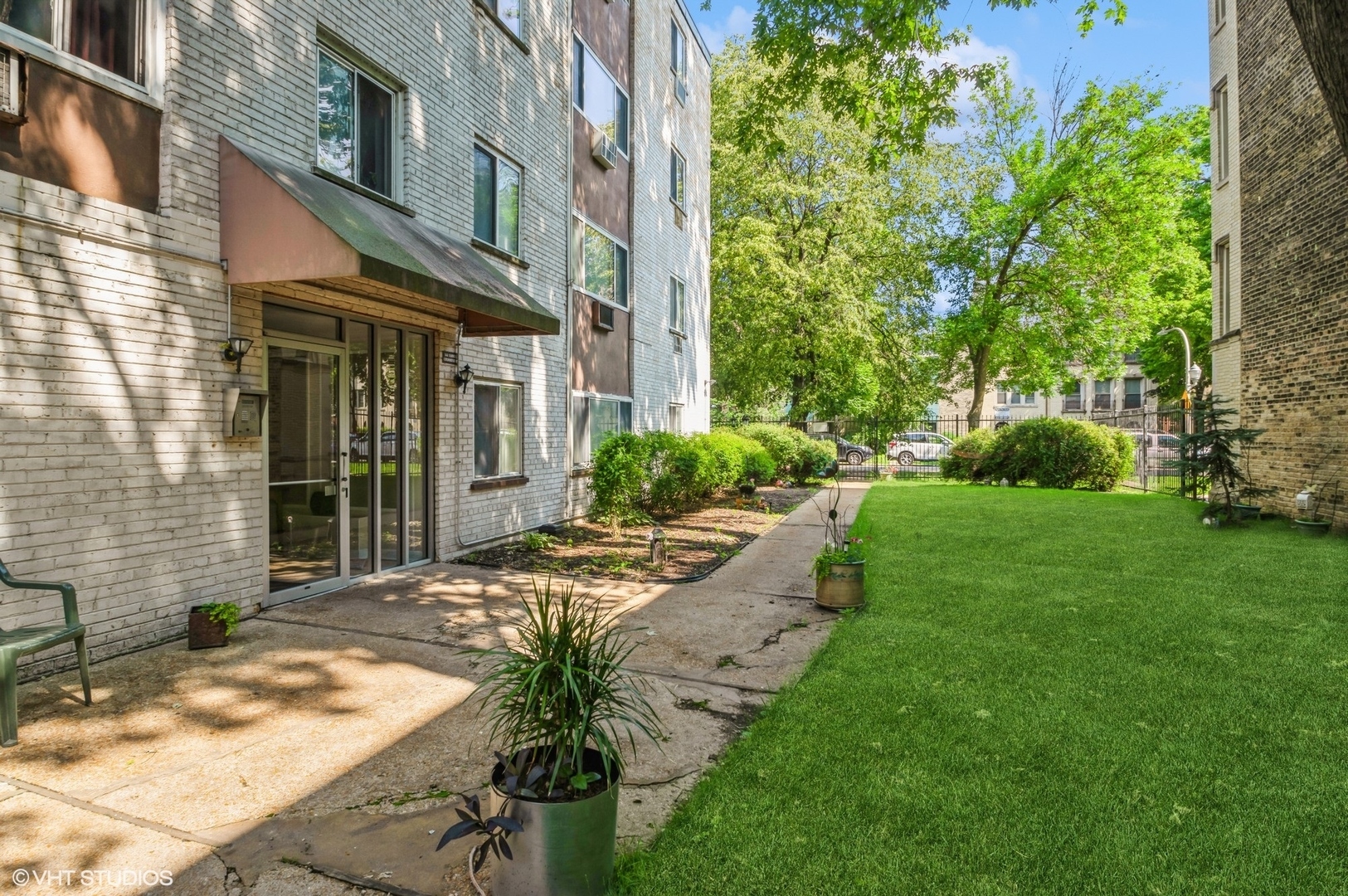 a view of a house with brick walls and a yard with plants