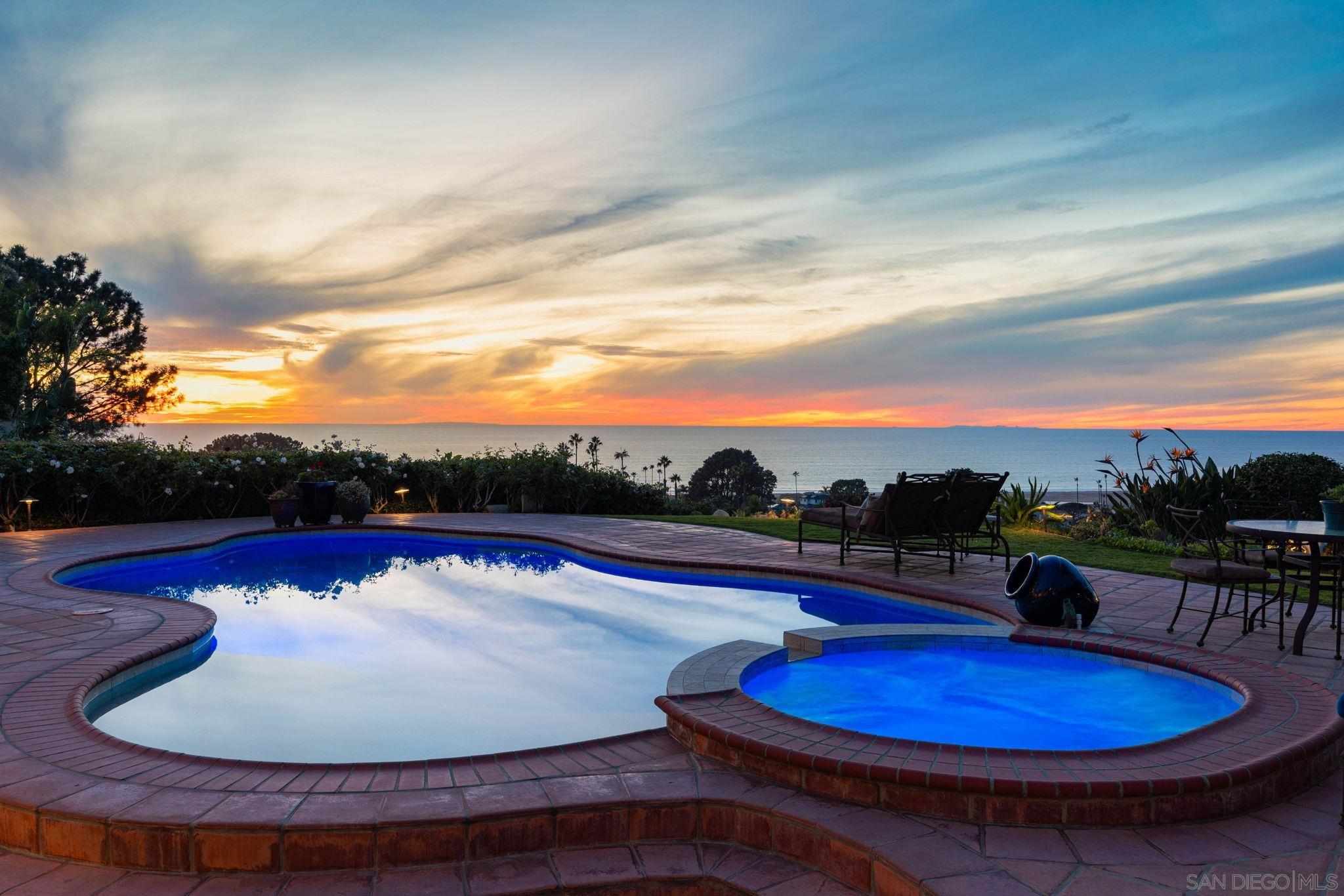 a view of a swimming pool with a table and chairs