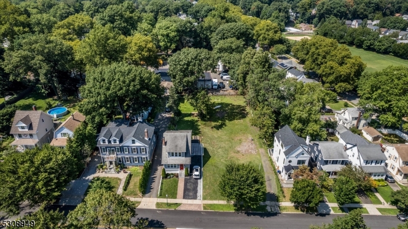 an aerial view of multiple houses with yard