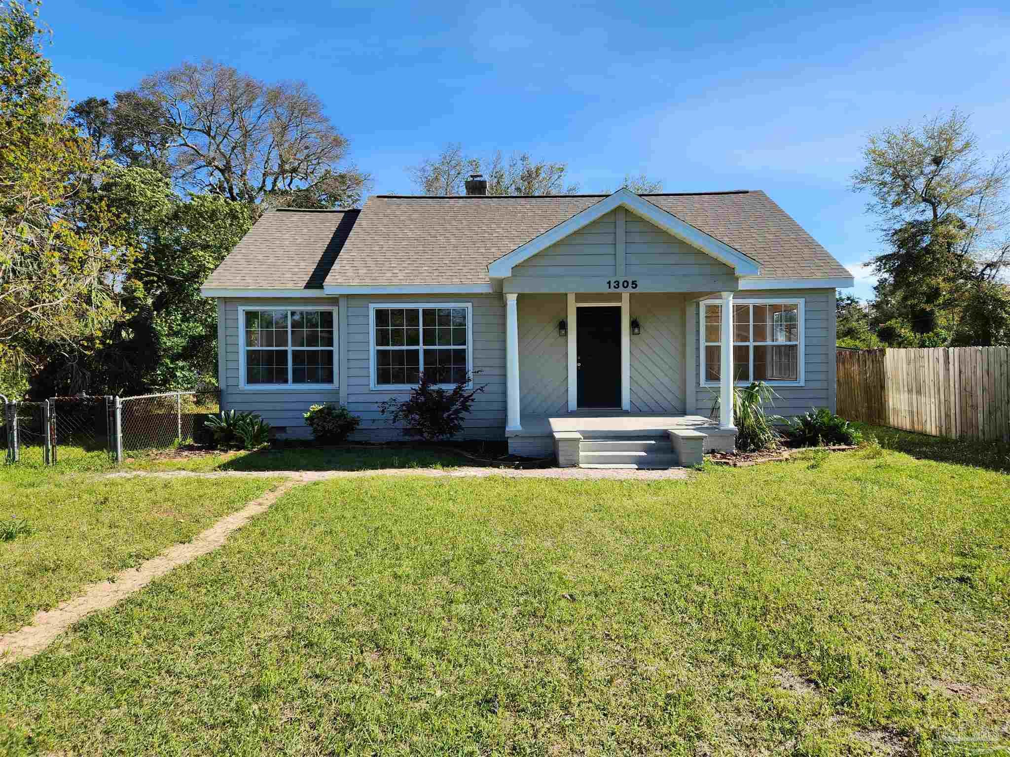 a front view of house with yard and green space