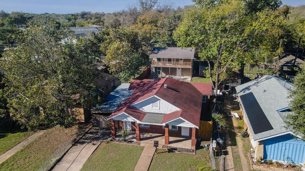 an aerial view of a house with a big yard