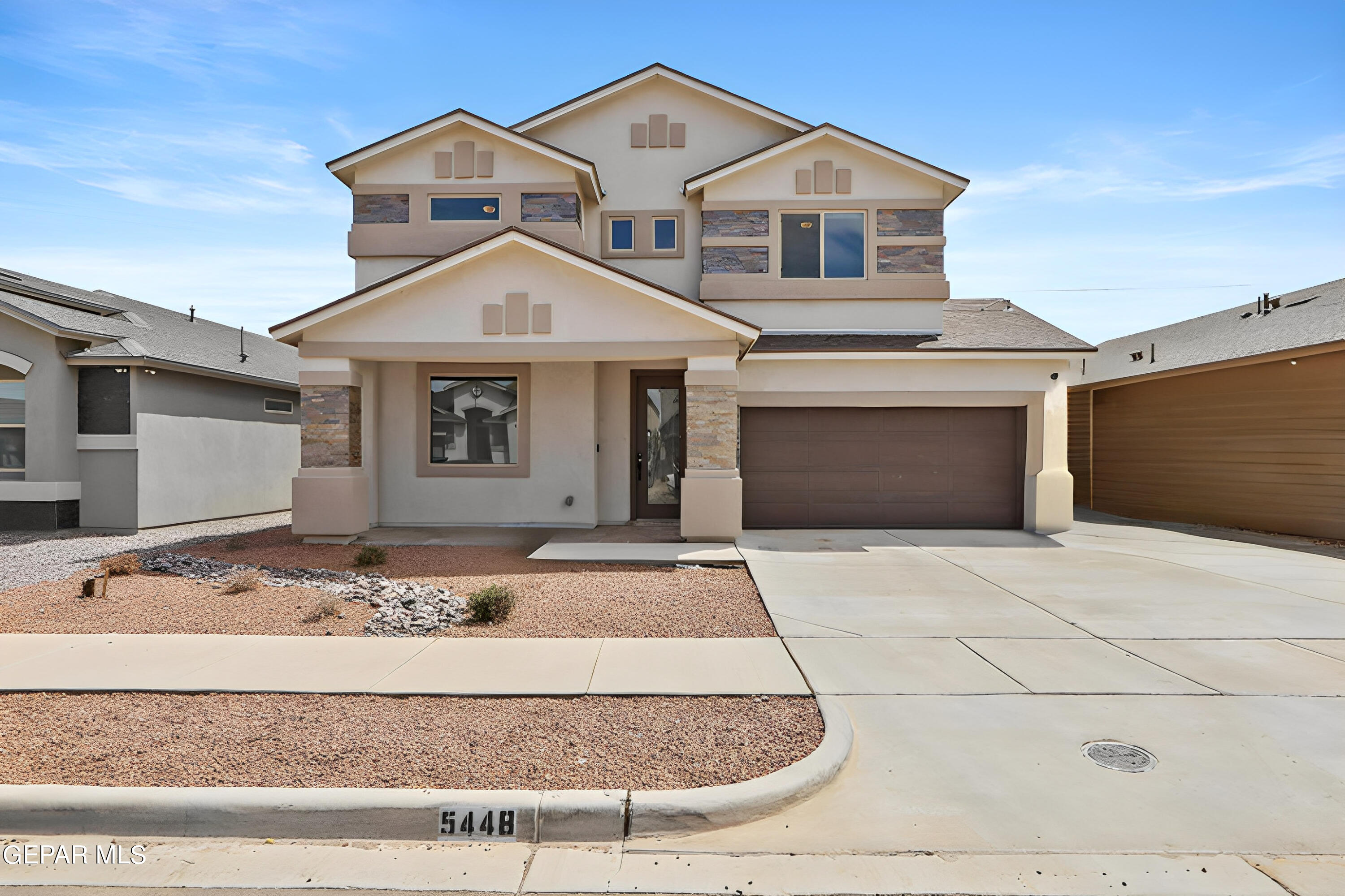 a front view of a house with garage