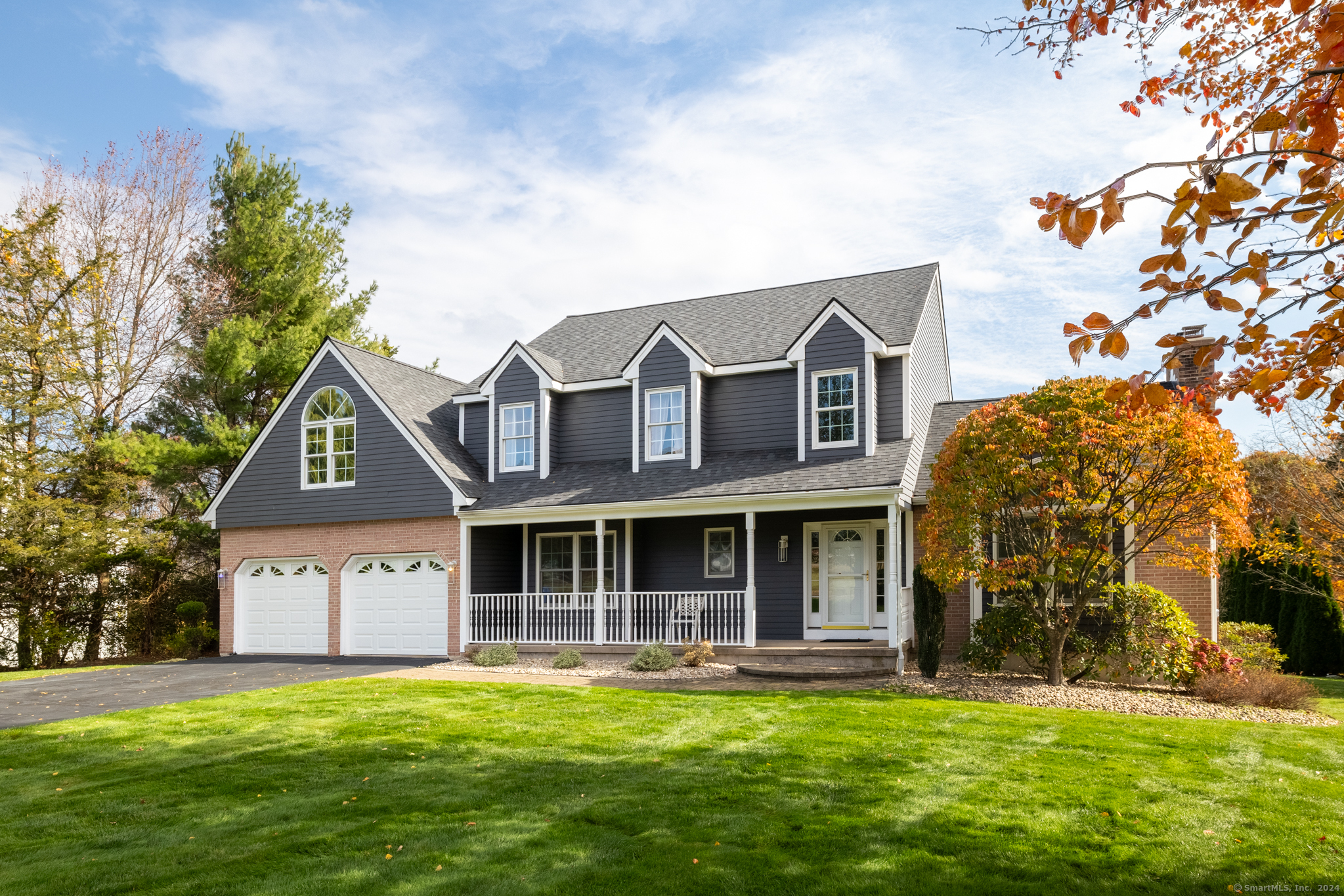 a front view of a house with a garden