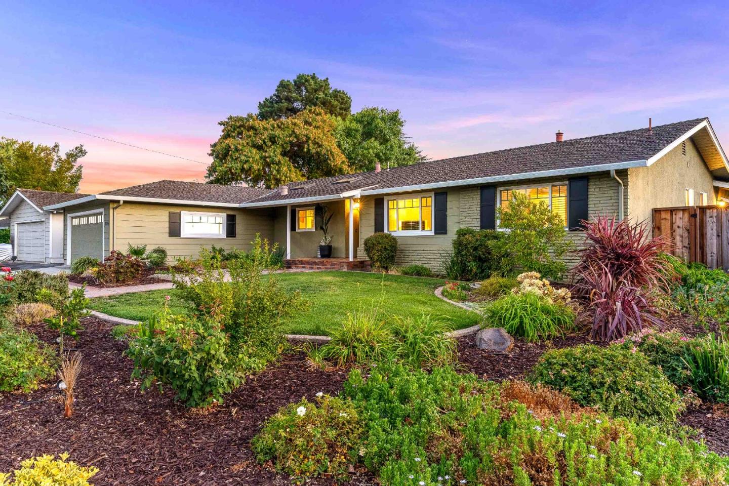 a front view of a house with garden