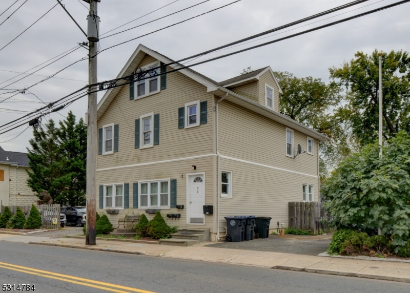 a front view of a house with a street