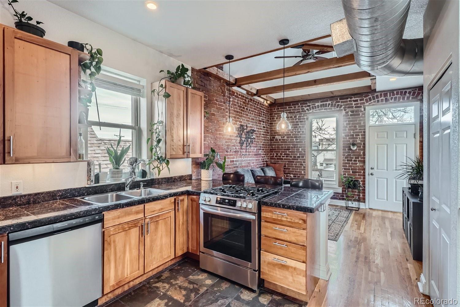 a kitchen with stainless steel appliances granite countertop a sink and cabinets