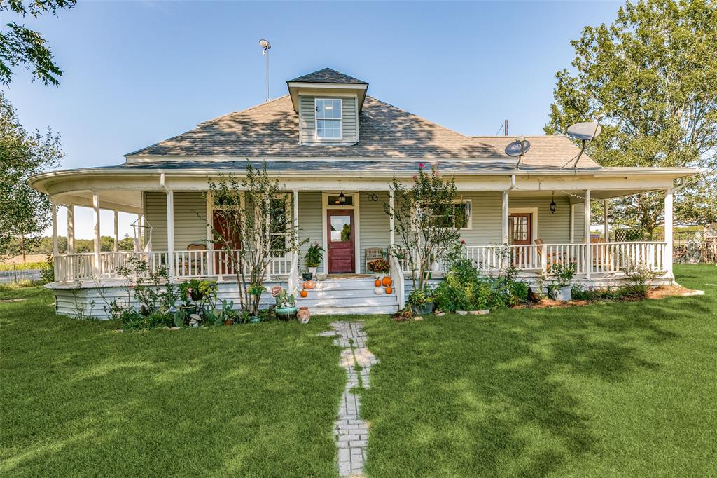 a front view of house with yard and outdoor seating