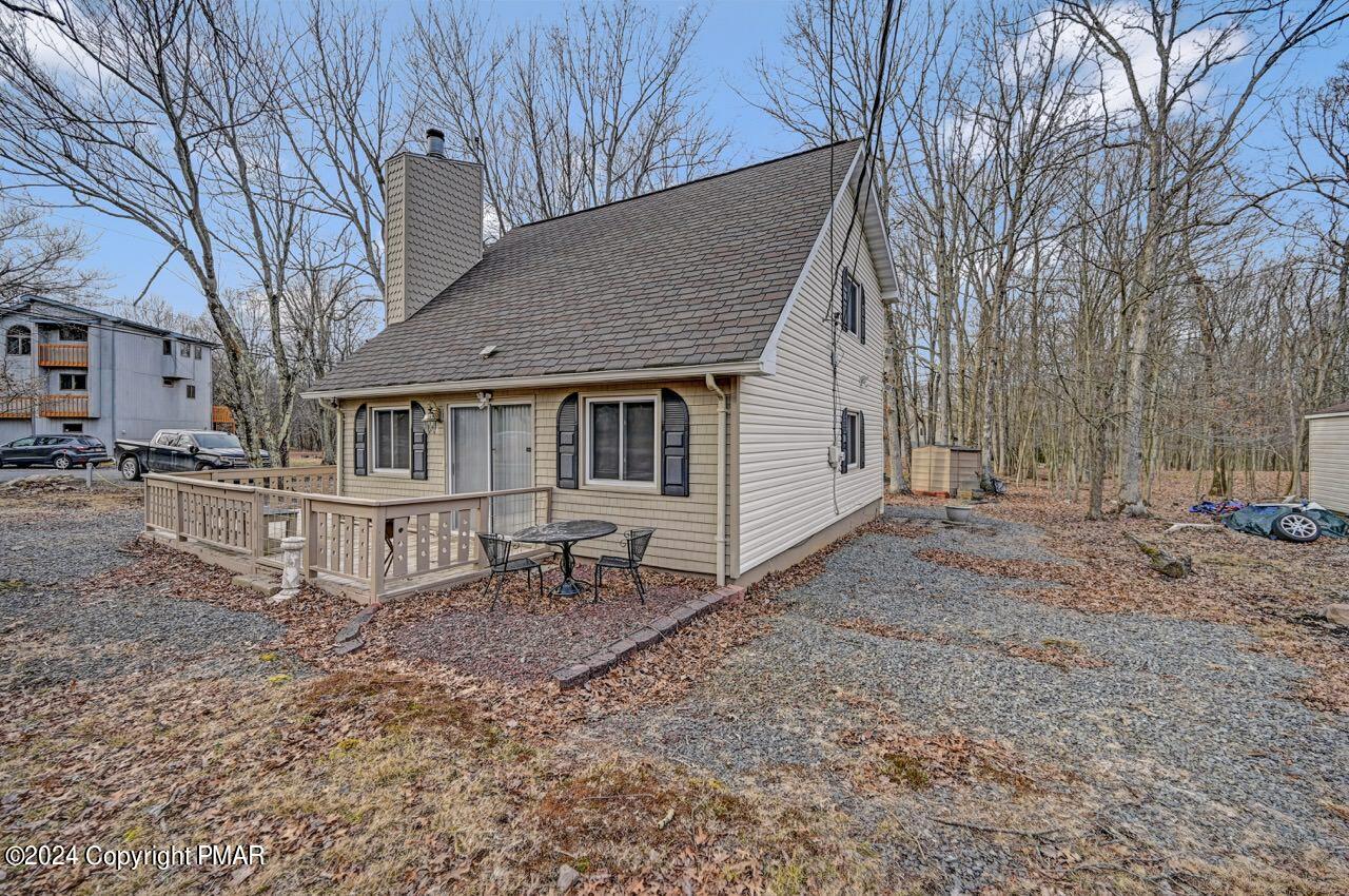 a view of a house with a yard and sitting area