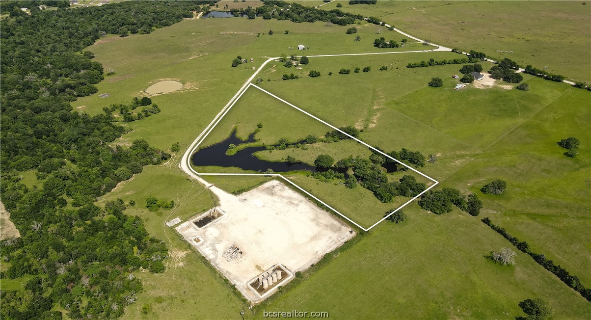 an aerial view of a residential houses with outdoor space