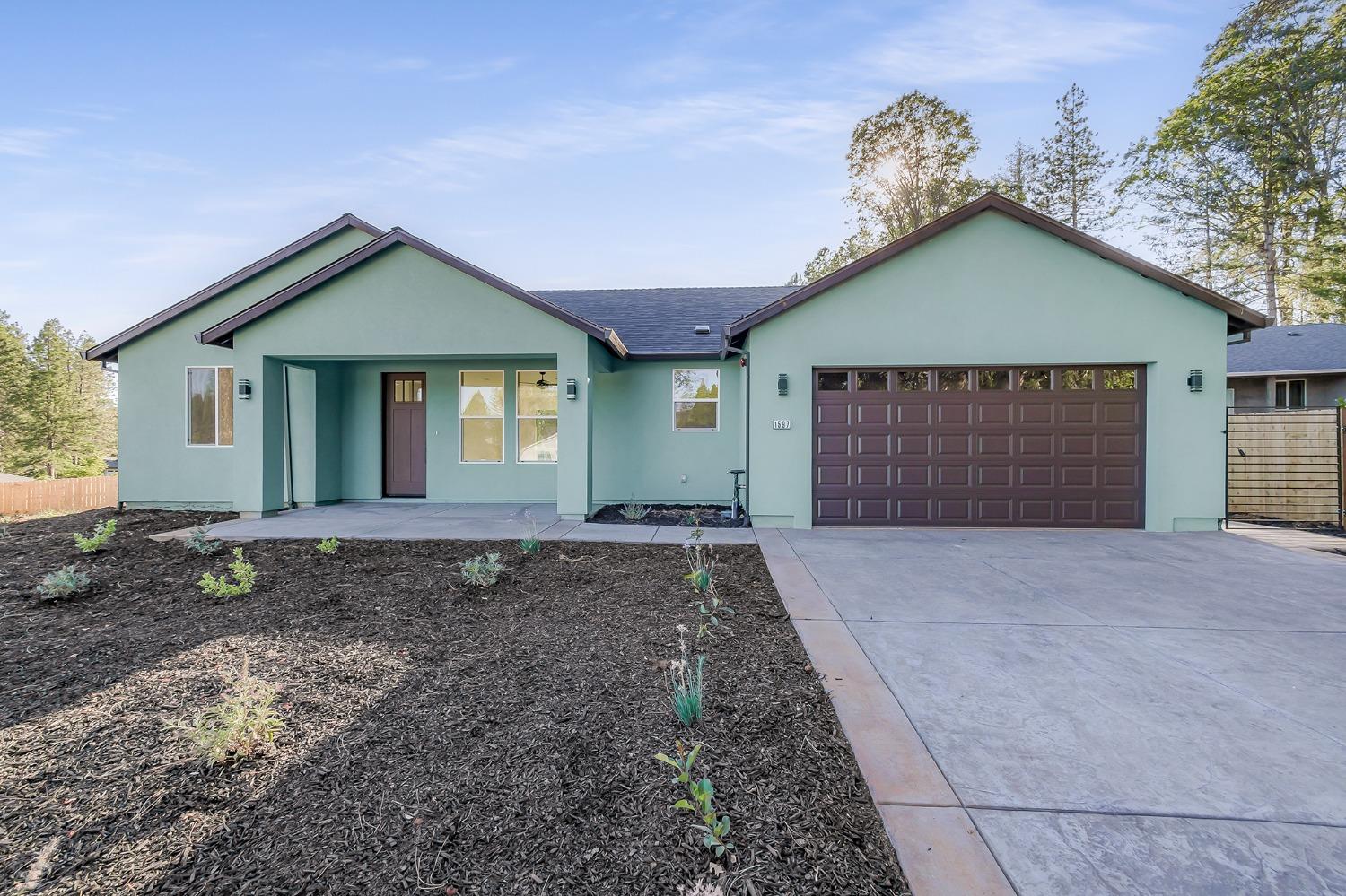 a view of a house with a yard and garage